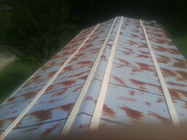 Rusted metal roof panels with new wood purlins before replacement — Storm Damage Roof Repair in Prudence Island by Roofing Brothers